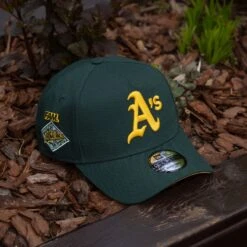 NEW ERA 9FORTY A-FRAME MLB OAKLAND ATHLETICS 25TH ANNIVERSARY DARK GREEN / GOLD UV SNAPBACK CAP